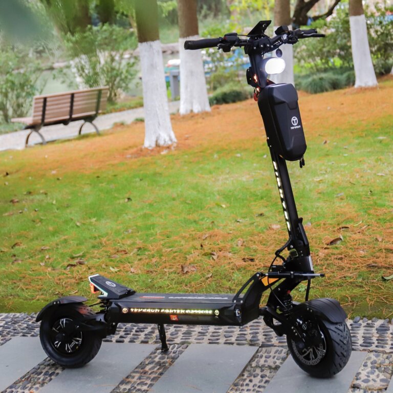 A black electric scooter, Fighter Supreme, parked in a park.