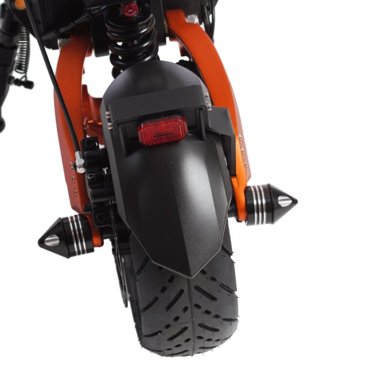 A close up view of an orange motorcycle.