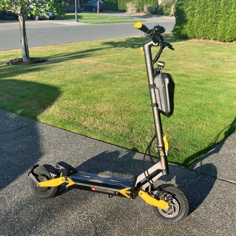 A Blade Mini Pro scooter is parked in front of a house.