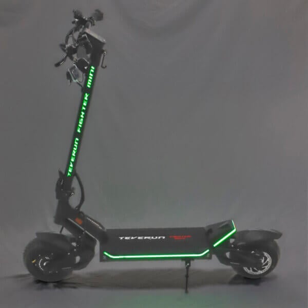 A Fighter Mini electric scooter with green lights on it.