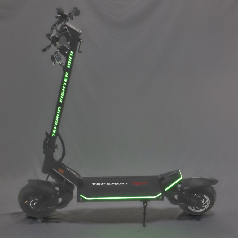 A Fighter Mini electric scooter with green lights on it.