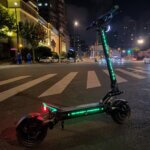 The Fighter 11 scooter illuminating the street at night.
