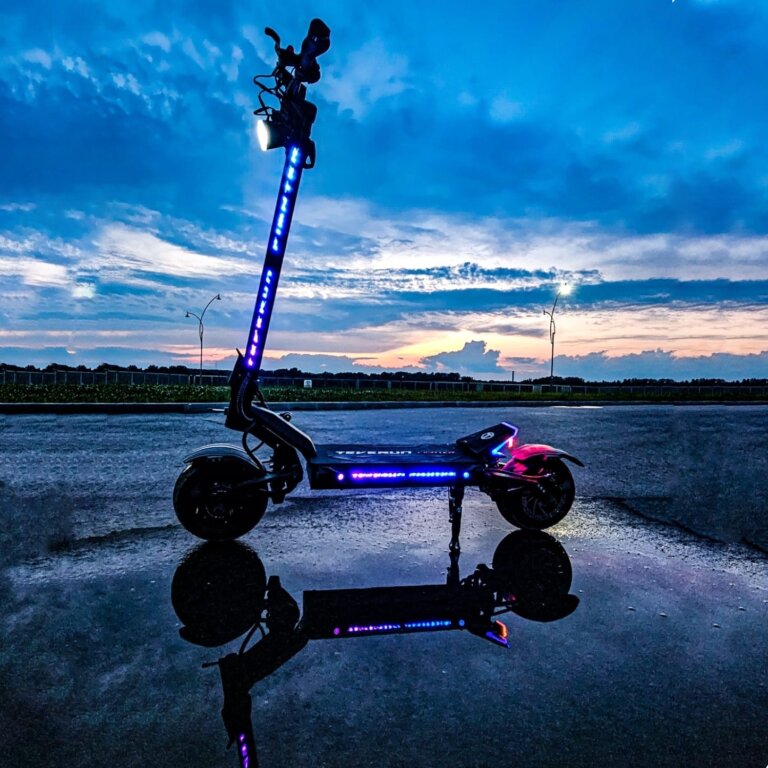 A scooter, reminiscent of a Fighter 11, perched atop a glistening puddle at dusk.